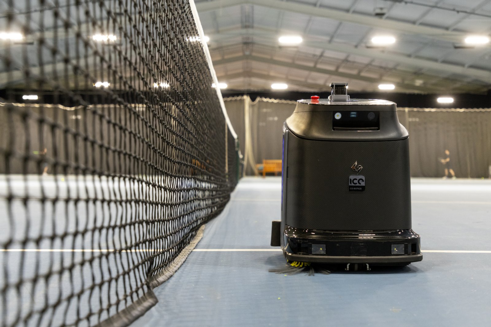 Autonomous scrubber cleaning a sports hall floor
