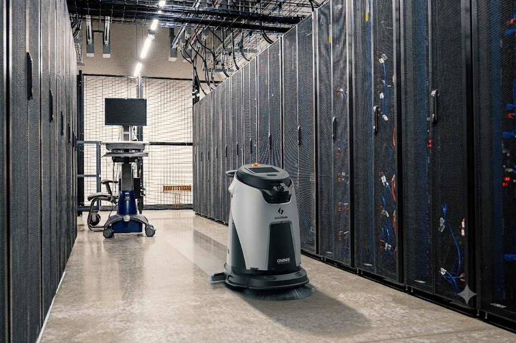 Autonomous scrubber cleaning the aisle of a data-centre server hall